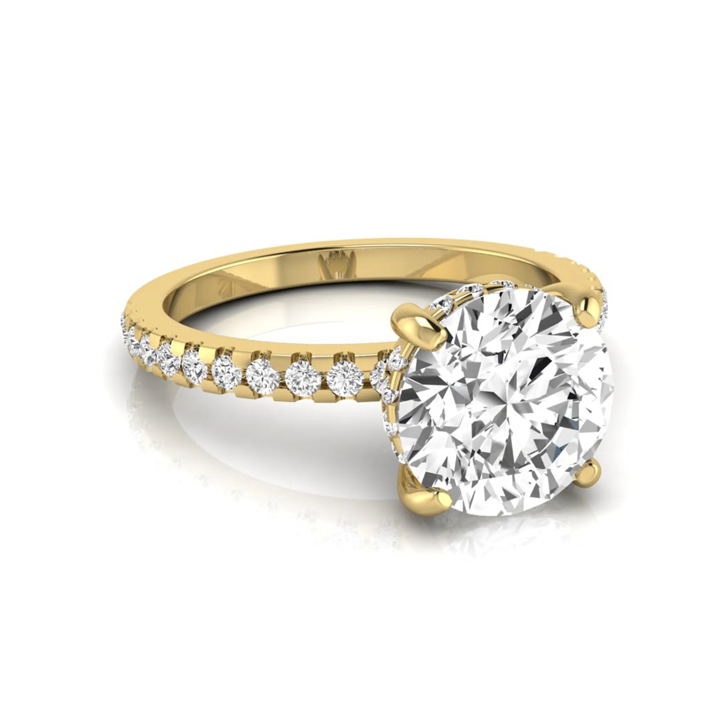 Round cut lab grown diamond engagement ring featuring a hidden halo, pavé accent side diamonds, and a four-prong setting in a yellow gold tone with an IGI certified 1.28 carat center diamond.