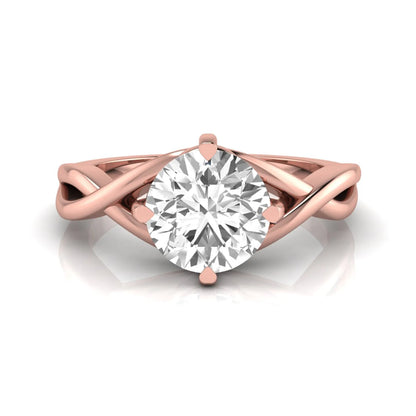 Round cut lab grown diamond engagement ring featuring a four-prong solitaire setting with an infinity-inspired crossover shank and polished rose gold tone band.