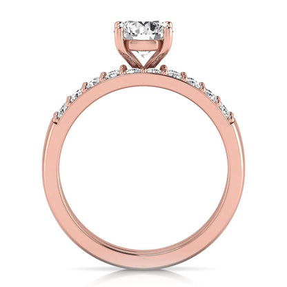 Round cut lab grown diamond bridal ring set featuring a 1.03 carat IGI certified solitaire engagement ring with a double pavé diamond band and matching diamond wedding band in polished rose gold.