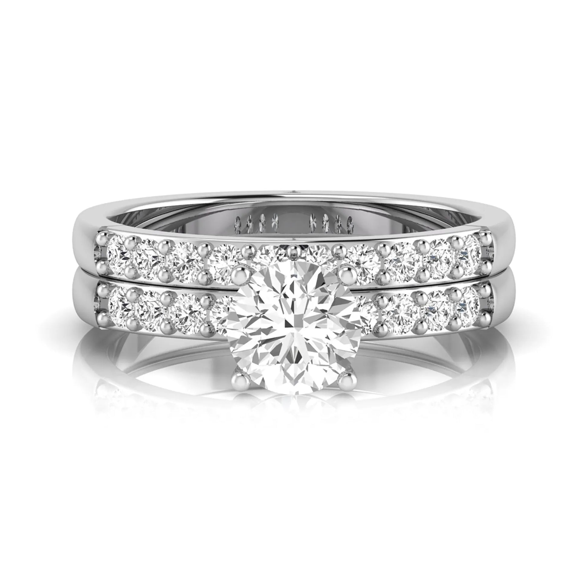 Round cut lab grown diamond bridal ring set featuring a 1.03 carat IGI certified solitaire engagement ring with a double pavé diamond band and matching diamond wedding band in polished white gold.