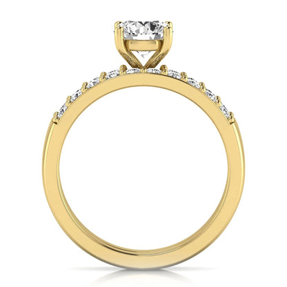 Round cut lab grown diamond bridal ring set featuring a 1.03 carat IGI certified solitaire engagement ring with a double pavé diamond band and matching diamond wedding band in polished yellow gold.