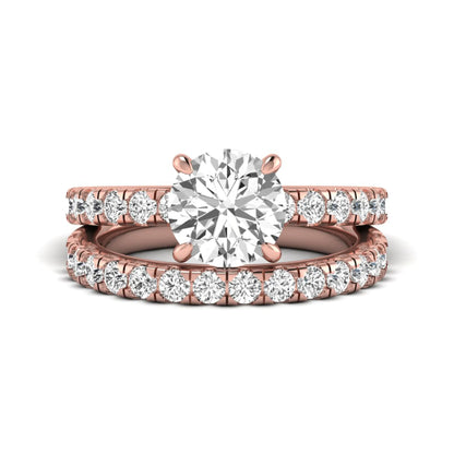 Round cut lab grown diamond bridal ring set in rose gold featuring a 1.67 carat IGI certified center diamond with matching diamond wedding band.