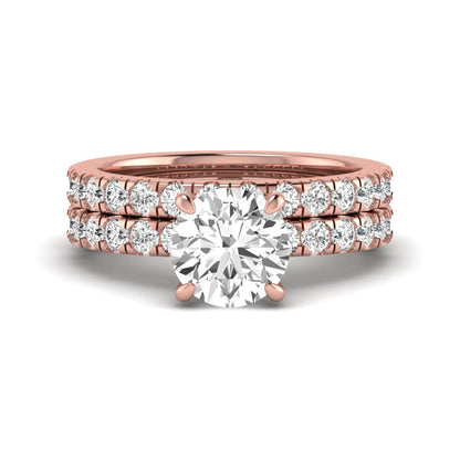 Round cut lab grown diamond bridal ring set in rose gold featuring a 1.67 carat IGI certified center diamond with matching diamond wedding band.