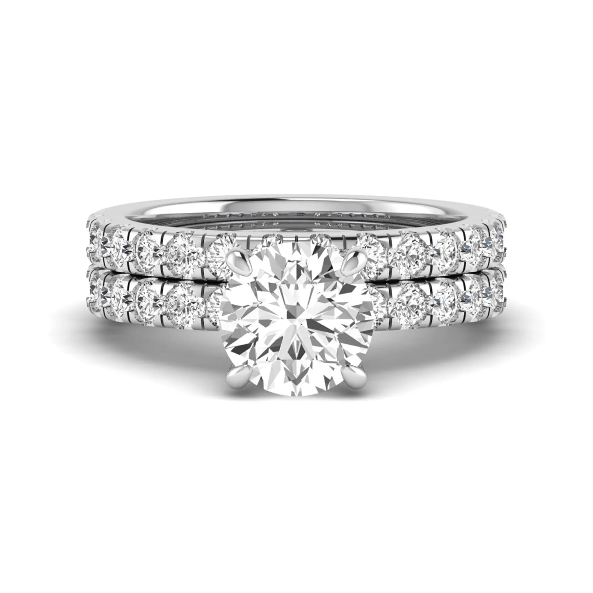 Round cut lab grown diamond bridal ring set in white gold featuring a 1.67 carat IGI certified center diamond with matching diamond wedding band.