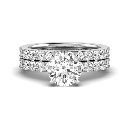 Round cut lab grown diamond bridal ring set in white gold featuring a 1.67 carat IGI certified center diamond with matching diamond wedding band.