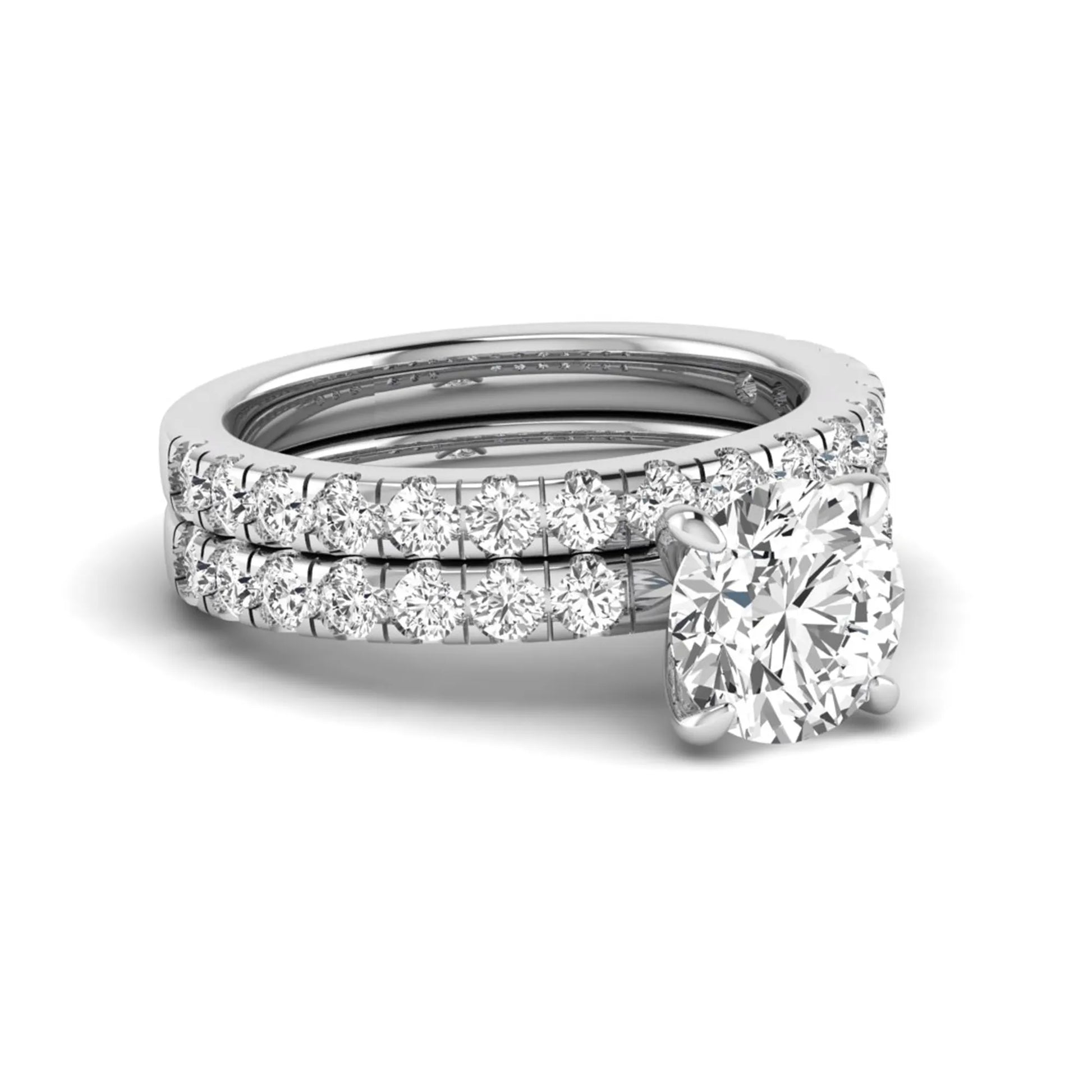 Round cut lab grown diamond bridal ring set in white gold featuring a 1.67 carat IGI certified center diamond with matching diamond wedding band.