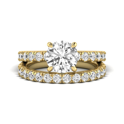 Round cut lab grown diamond bridal ring set in yellow gold featuring a 1.67 carat IGI certified center diamond with matching diamond wedding band.