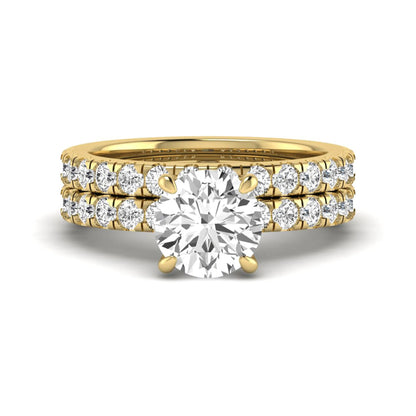 Round cut lab grown diamond bridal ring set in yellow gold featuring a 1.67 carat IGI certified center diamond with matching diamond wedding band.