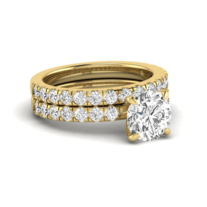 Round cut lab grown diamond bridal ring set in yellow gold featuring a 1.67 carat IGI certified center diamond with matching diamond wedding band.