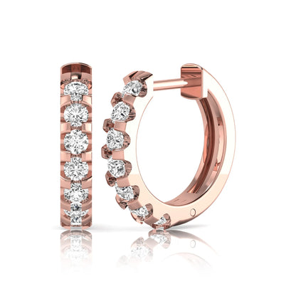 Round lab grown diamond half eternity huggie hoop earrings featuring a continuous row of round brilliant diamonds in a shared prong setting in rose gold