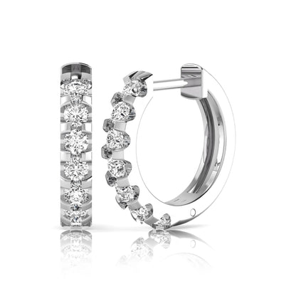 Round lab grown diamond half eternity huggie hoop earrings featuring a continuous row of round brilliant diamonds in a shared prong setting in white gold