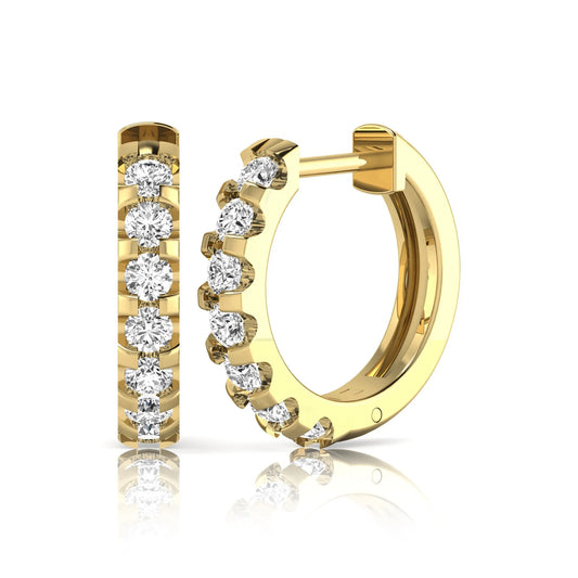 Round lab grown diamond half eternity huggie hoop earrings featuring a continuous row of round brilliant diamonds in a shared prong setting in yellow gold