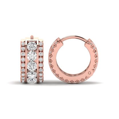 Round cut lab grown diamond multi-row huggie hoop earrings featuring a center row of diamonds with side accent diamonds and a hinged snap closure in a rose gold tone.