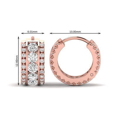 Round cut lab grown diamond multi-row huggie hoop earrings featuring a center row of diamonds with side accent diamonds and a hinged snap closure in a rose gold tone.
