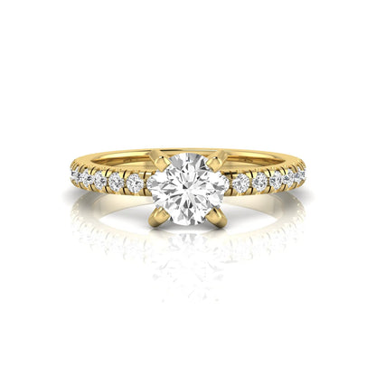 Round lab grown diamond pavé solitaire engagement ring featuring a 1.00 carat IGI certified round brilliant diamond with pavé diamond band in yellow gold.