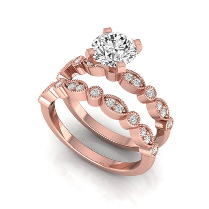 Round milgrain vintage lab grown diamond bridal ring set featuring a 1.28 carat IGI certified round center diamond with matching vintage-inspired diamond wedding band in a rose gold design.