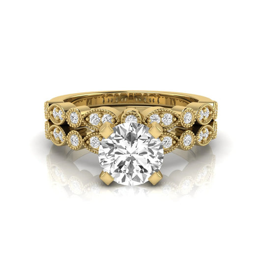 Round milgrain vintage lab grown diamond bridal ring set featuring a 1.28 carat IGI certified round center diamond with matching vintage-inspired diamond wedding band in a yellow gold design.