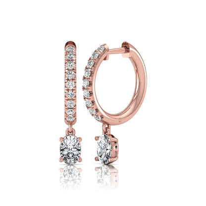 Round and oval cut lab grown diamond pavé drop huggie hoop earrings featuring sparkling round diamonds on the hoop, an oval diamond drop, hinged snap closure, and polished rose gold tone finish.