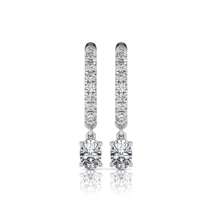 Round and oval cut lab grown diamond pavé drop huggie hoop earrings featuring sparkling round diamonds on the hoop, an oval diamond drop, hinged snap closure, and polished white gold tone finish.