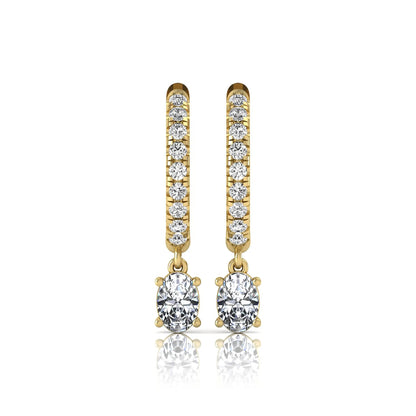 Round and oval cut lab grown diamond pavé drop huggie hoop earrings featuring sparkling round diamonds on the hoop, an oval diamond drop, hinged snap closure, and polished yellow gold tone finish.
