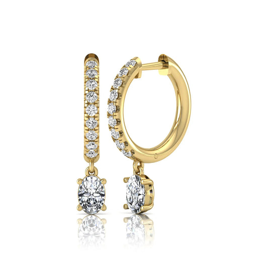 Round and oval cut lab grown diamond pavé drop huggie hoop earrings featuring sparkling round diamonds on the hoop, an oval diamond drop, hinged snap closure, and polished yellow gold tone finish.