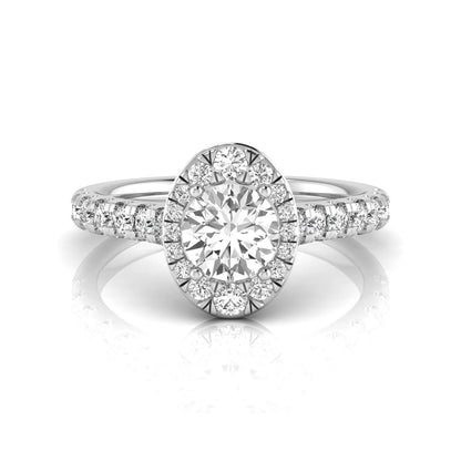 Round cut lab grown diamond engagement ring with an oval-shaped halo of round diamonds, pavé side stones, and a white gold style band.