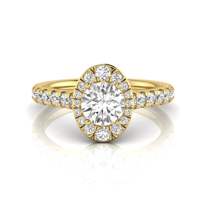 Round cut lab grown diamond engagement ring with an oval-shaped halo of round diamonds, pavé side stones, and a yellow gold style band.