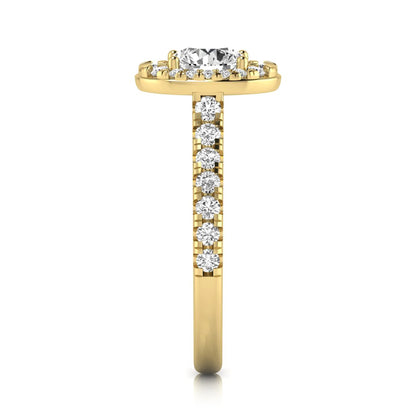 Round cut lab grown diamond engagement ring with an oval-shaped halo of round diamonds, pavé side stones, and a yellow gold style band.
