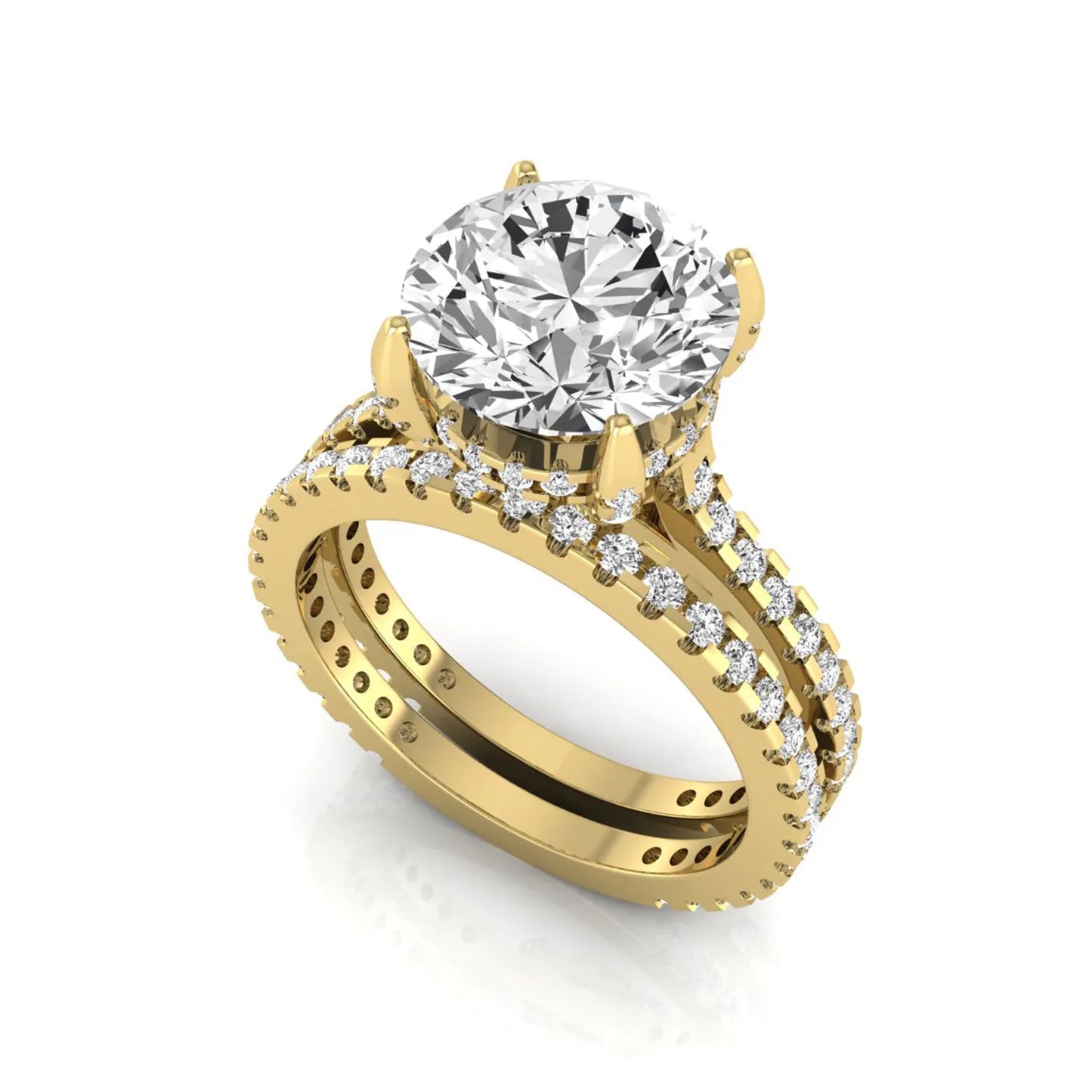 Round cut lab grown diamond bridal ring set featuring an IGI certified center diamond with matching pavé diamond wedding band in a classic four-prong setting in yellow gold