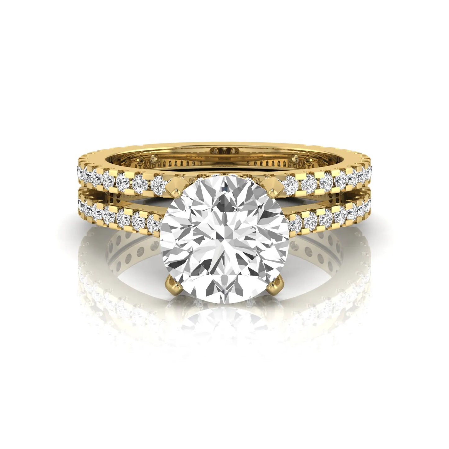 Round cut lab grown diamond bridal ring set featuring an IGI certified center diamond with matching pavé diamond wedding band in a classic four-prong setting in yellow gold