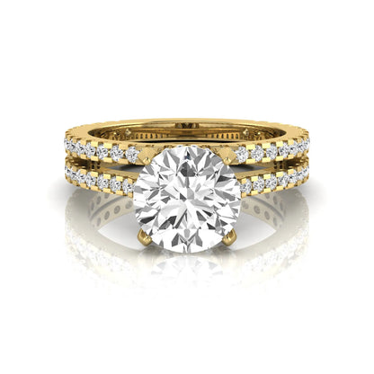 Round cut lab grown diamond bridal ring set featuring an IGI certified center diamond with matching pavé diamond wedding band in a classic four-prong setting in yellow gold
