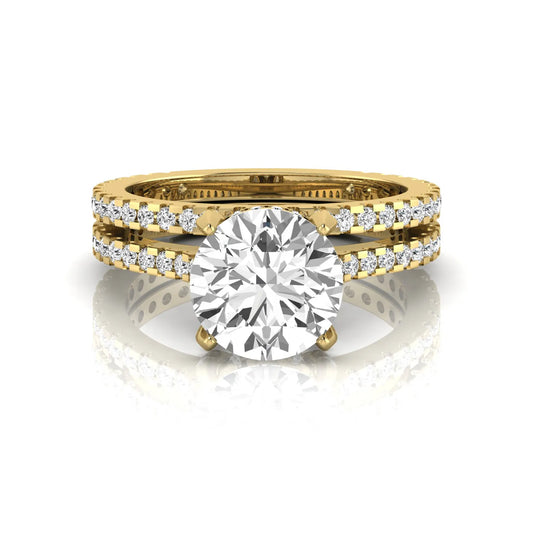 Round cut lab grown diamond bridal ring set featuring an IGI certified center diamond with matching pavé diamond wedding band in a classic four-prong setting in yellow gold