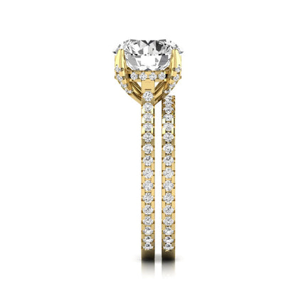 Round cut lab grown diamond bridal ring set featuring an IGI certified center diamond with matching pavé diamond wedding band in a classic four-prong setting in yellow gold