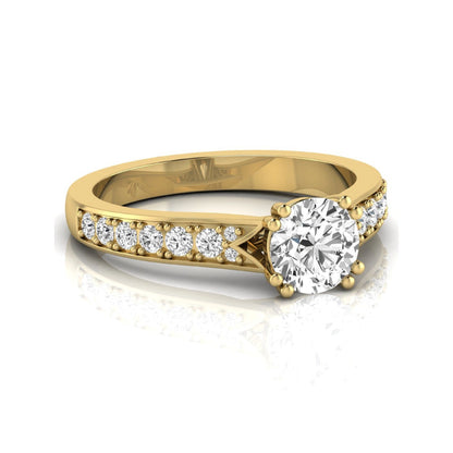 Round cut lab grown diamond engagement ring featuring an IGI certified center diamond with pavé set round diamonds on a tapered band in a classic six-prong setting in yellow gold