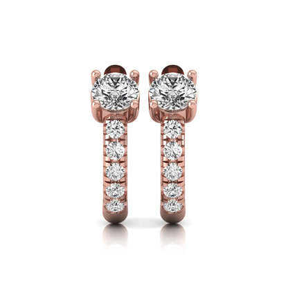 Round brilliant lab grown diamond huggie hoop earrings featuring an elevated four prong center diamond with graduated shared prong pavé round diamond accents in rose gold.