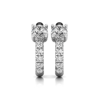 Round brilliant lab grown diamond huggie hoop earrings featuring an elevated four prong center diamond with graduated shared prong pavé round diamond accents in white gold.