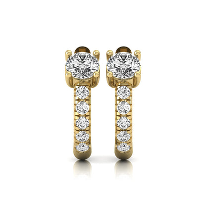 Round brilliant lab grown diamond huggie hoop earrings featuring an elevated four prong center diamond with graduated shared prong pavé round diamond accents in yellow gold.