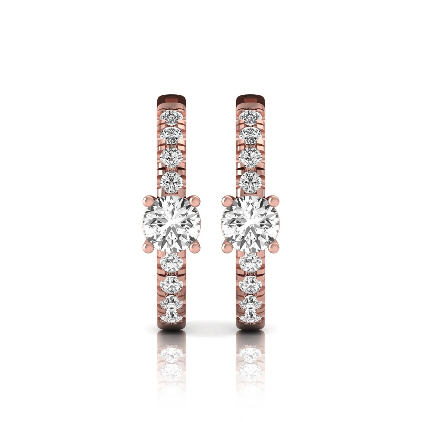 Round brilliant lab grown diamond pavé huggie hoop earrings featuring a four prong center diamond with graduated shared prong pavé round diamonds in rose gold.