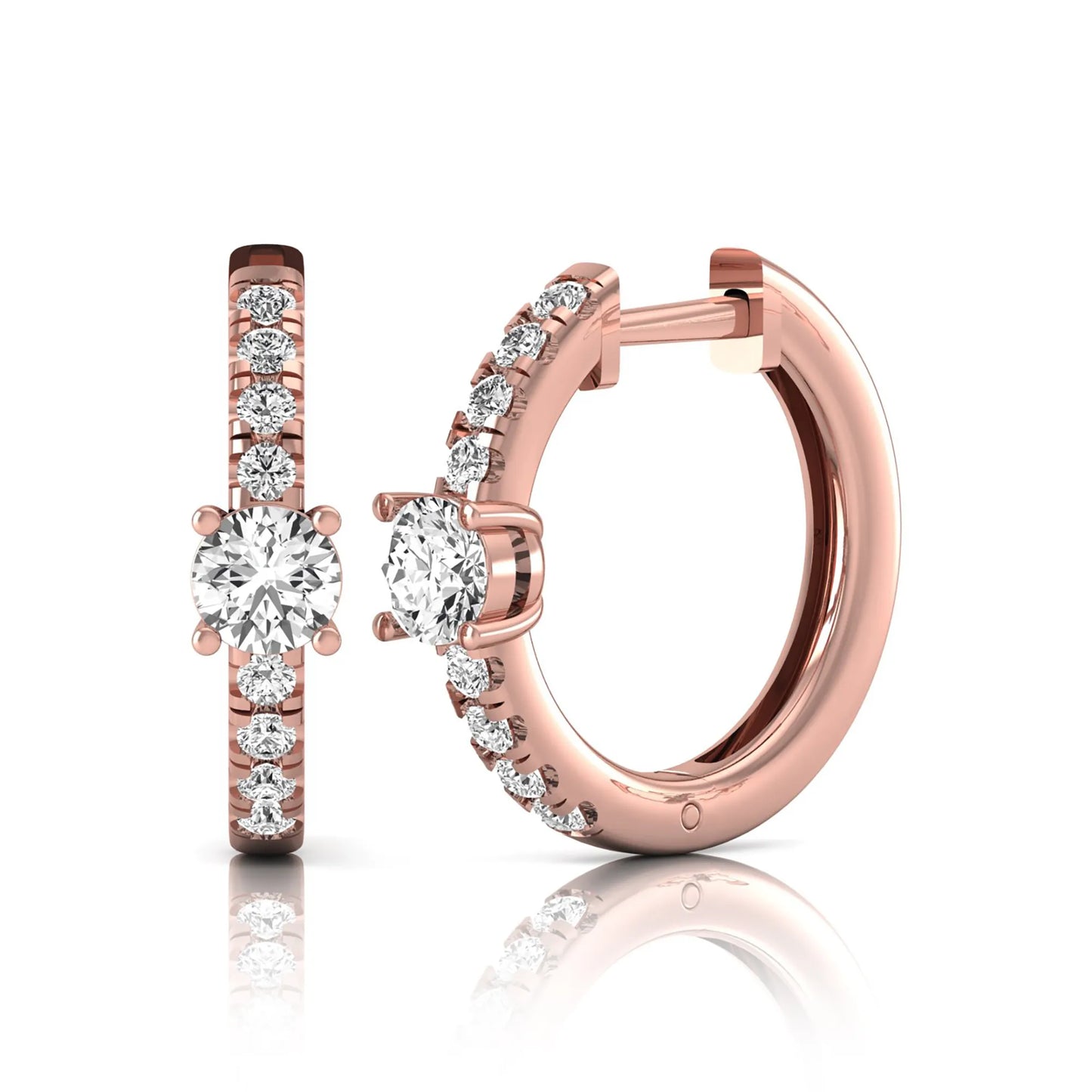 Round brilliant lab grown diamond pavé huggie hoop earrings featuring a four prong center diamond with graduated shared prong pavé round diamonds in rose gold.