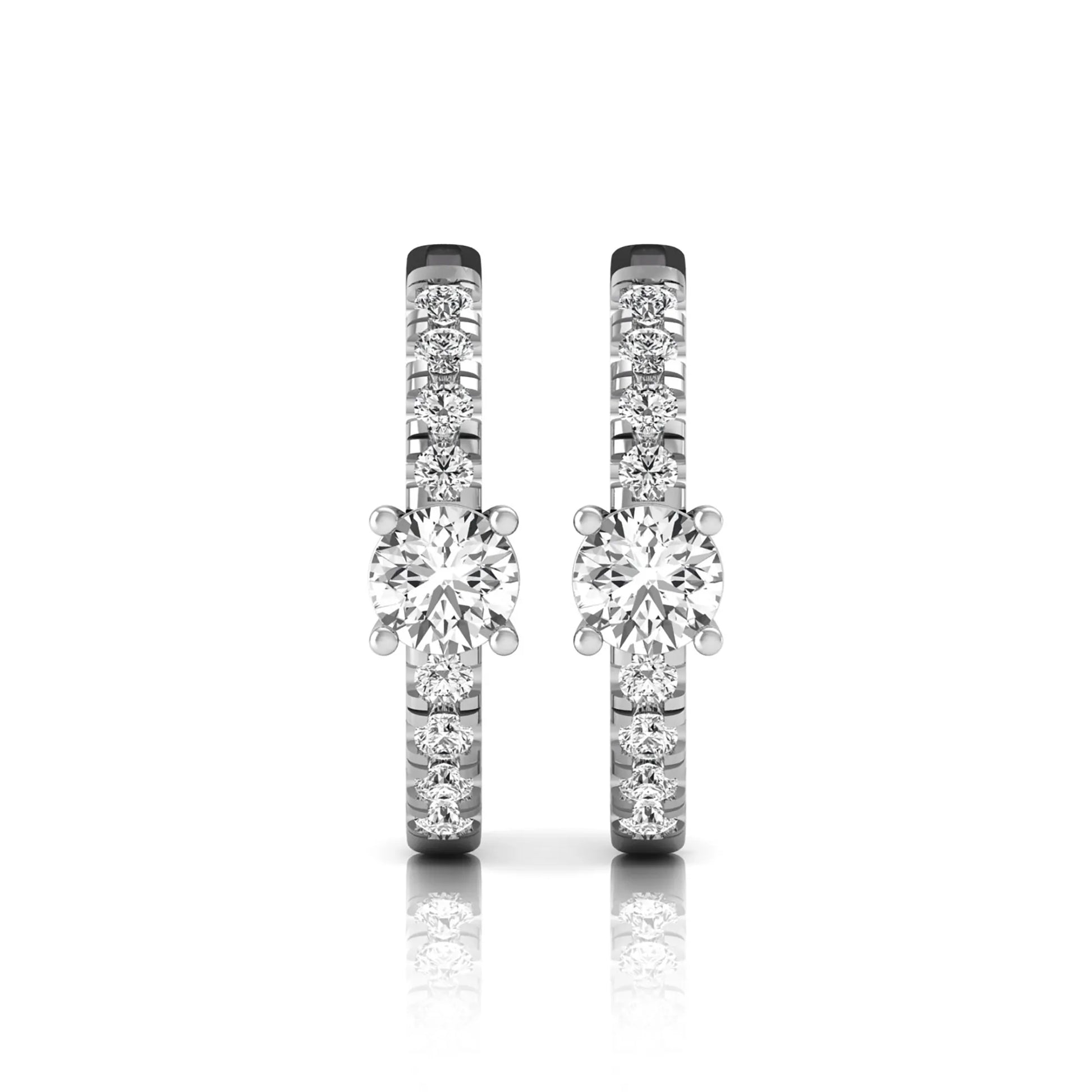 Round brilliant lab grown diamond pavé huggie hoop earrings featuring a four prong center diamond with graduated shared prong pavé round diamonds in white gold.