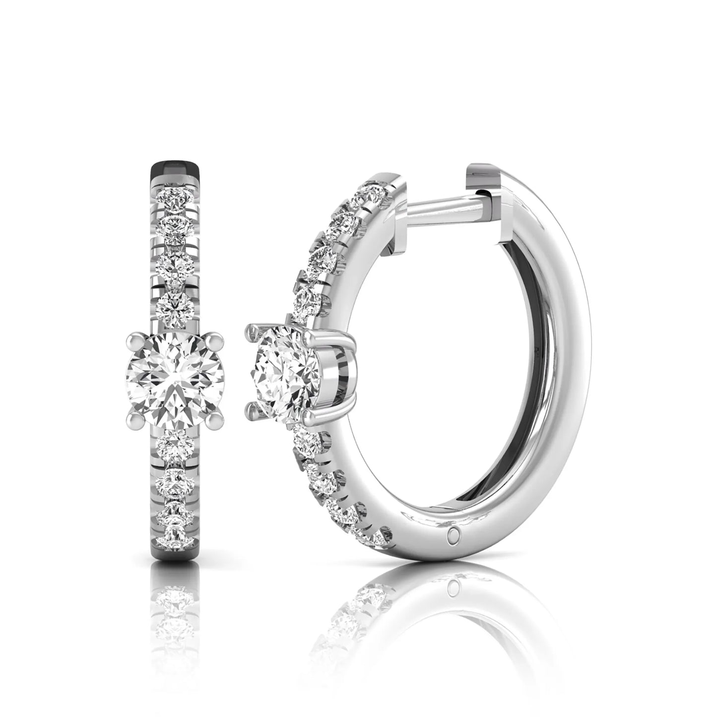Round brilliant lab grown diamond pavé huggie hoop earrings featuring a four prong center diamond with graduated shared prong pavé round diamonds in white gold.