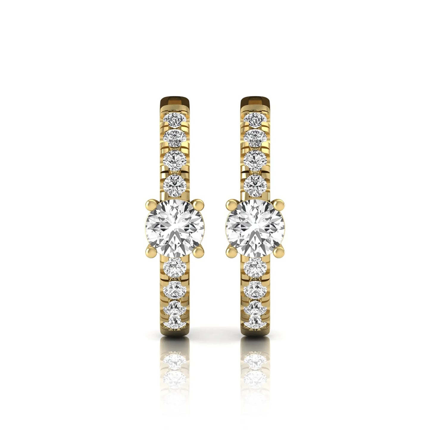 Round brilliant lab grown diamond pavé huggie hoop earrings featuring a four prong center diamond with graduated shared prong pavé round diamonds in yellow gold.