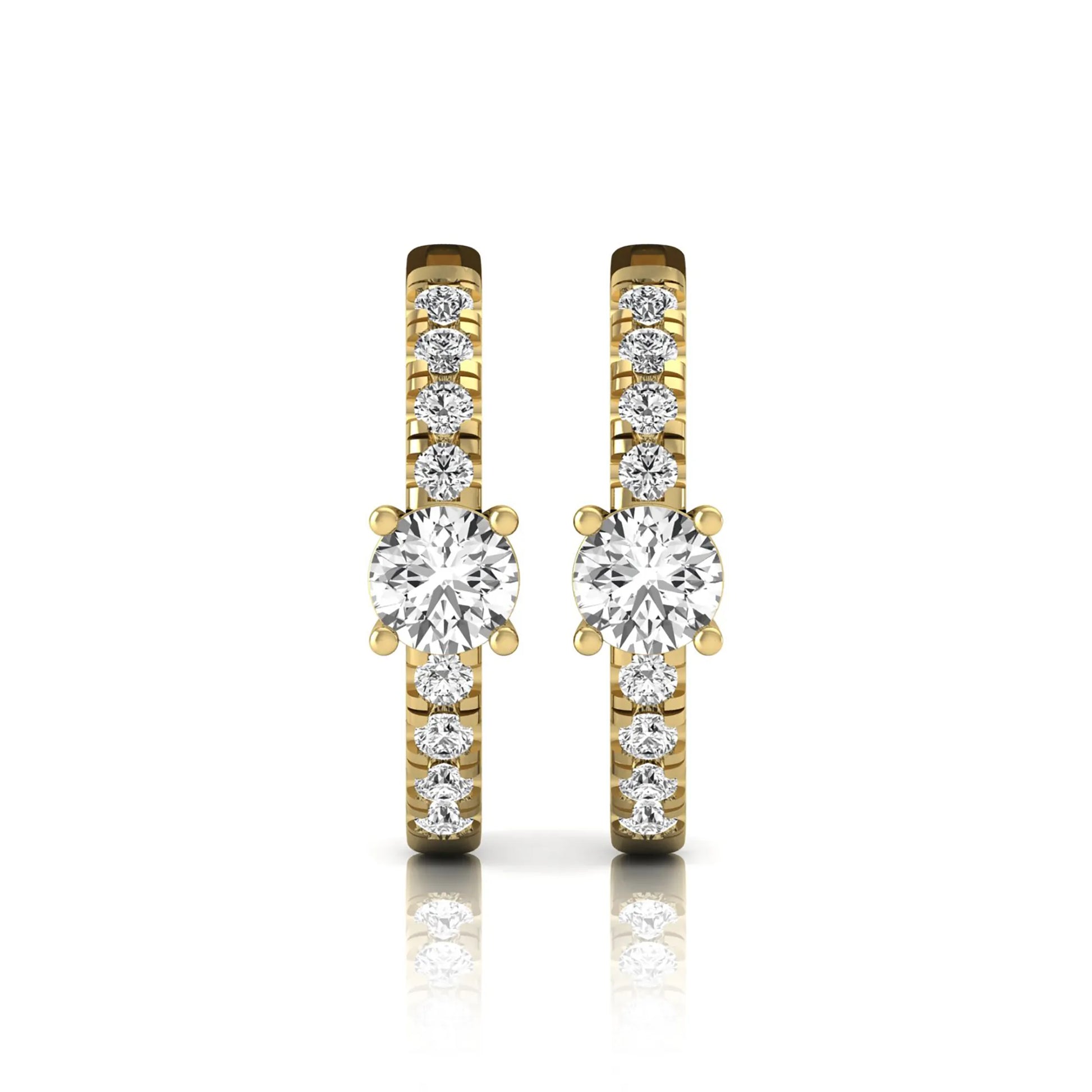 Round brilliant lab grown diamond pavé huggie hoop earrings featuring a four prong center diamond with graduated shared prong pavé round diamonds in yellow gold.