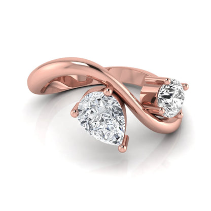 Round and pear cut lab grown diamond Toi et Moi ring with an elegant flowing crossover design in rose gold