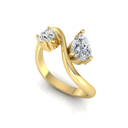 Round and pear cut lab grown diamond Toi et Moi ring with an elegant flowing crossover design in yellow gold