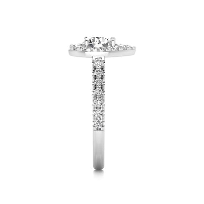 Round cut lab grown diamond engagement ring with a pear-shaped halo of round diamonds, pavé side stones, and a white gold style band.