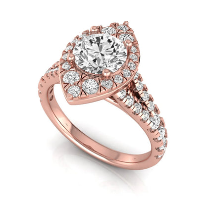 Round cut lab grown diamond engagement ring with a pear-shaped halo, split shank pavé band, and rose gold style.