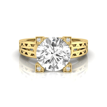 Round cut lab grown diamond engagement ring featuring a four-prong setting with round accent diamonds and a geometric yellow gold style openwork band.