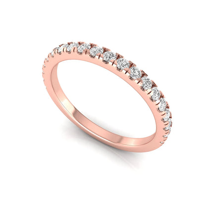 Round prong set lab grown diamond half eternity band ring featuring round diamonds in an elegant stackable wedding band design in rose gold