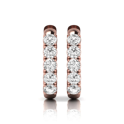 Round cut lab grown diamond front-facing huggie hoop earrings featuring a shared four prong setting, hinged snap closure, and polished rose gold finish.
